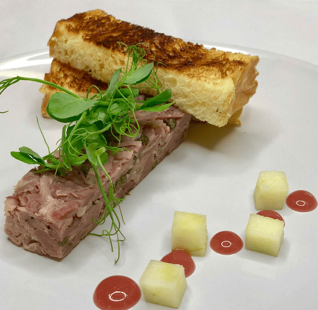 Starter dish of meat and bread on a white plate by a quality caterer in Essex- Plenty Of Thyme