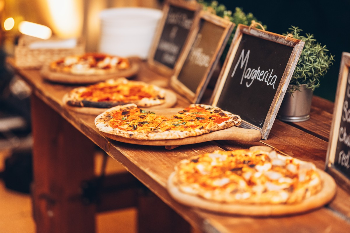Wood fired pizza station for relaxed birthday party catering at an outdoor family celebration 