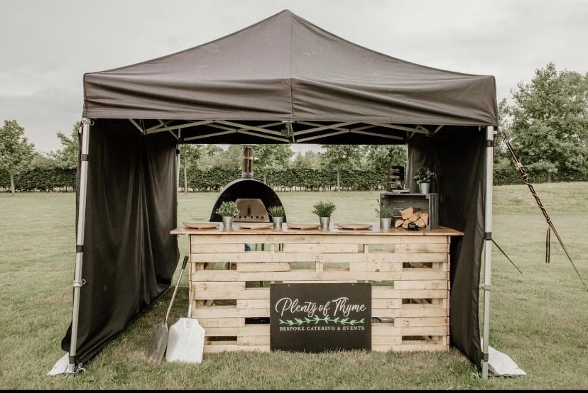 Marquee Caterers outdoor catering setup under a black marquee tent.